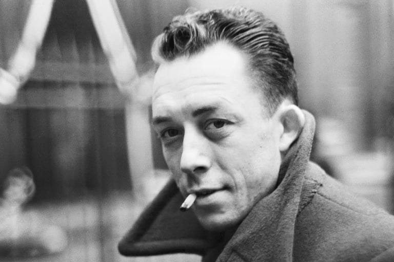 A black and white potrait of french writer ablert camus smoking a cigarette.