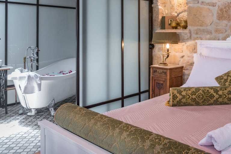 Convenient Queen size bed in open space bedroom with bathroom next to it in Villa Galanoussa Zakynthos