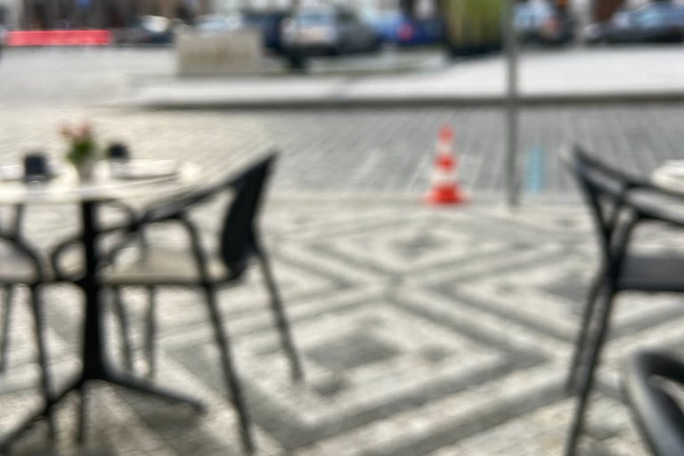 a table with a glass of wine and a glass of wine, blurry