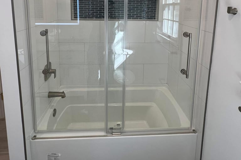 a new bathroom with a glass shower and a tub installed in South Jersey