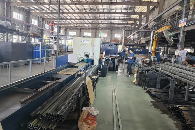 HSG laser tube cutting machine in a large metal fabrication factory with stacked steel profiles.