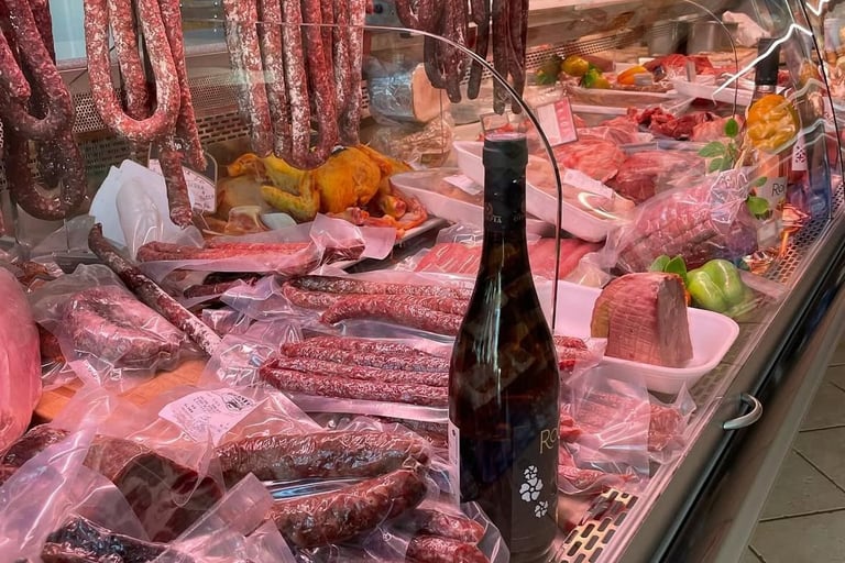 Display of cured meats, sausages, and vacuum-sealed salami at a traditional Italian butcher shop.