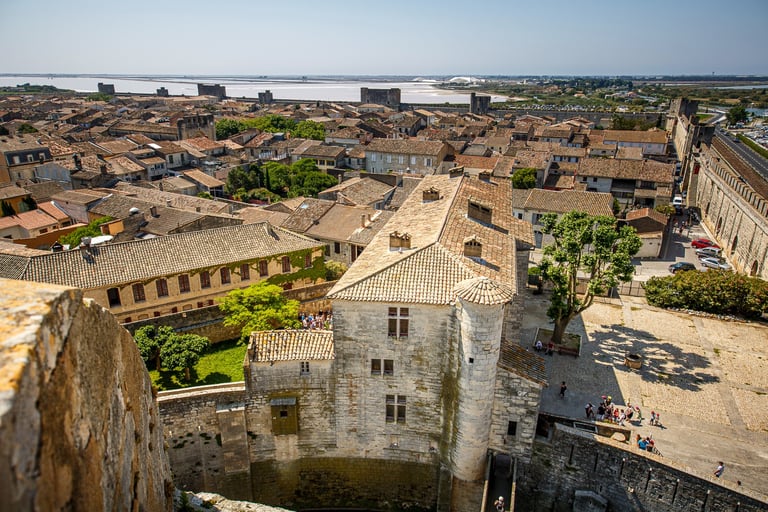 Aerial view of the medieval fortified city of Aigues-Mortes in France with stone walls and salt marshes.