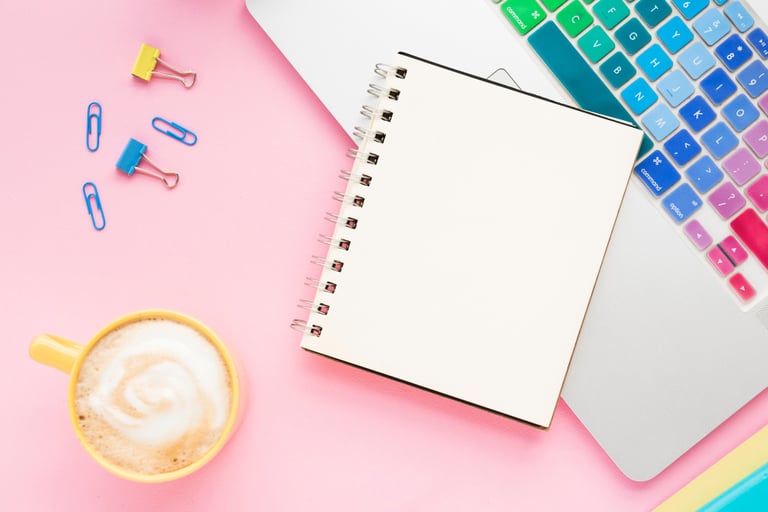 Creative workspace with laptop and notebook for brand strategy and marketing planning