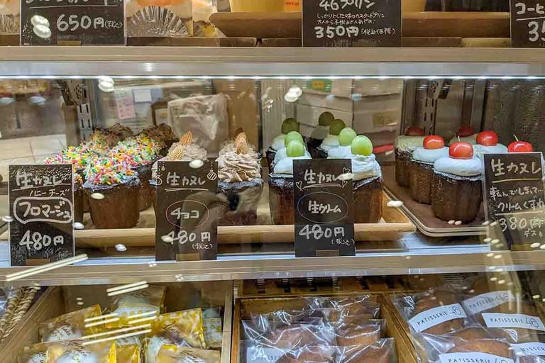 Display of Japanese pastries and decorated canelés in a bakery shop in Shizuoka, Japan.