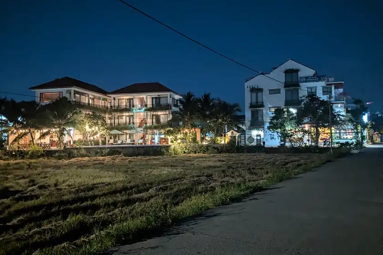 Quiet street and hotel buildings at night in Hoi An, Vietnam
