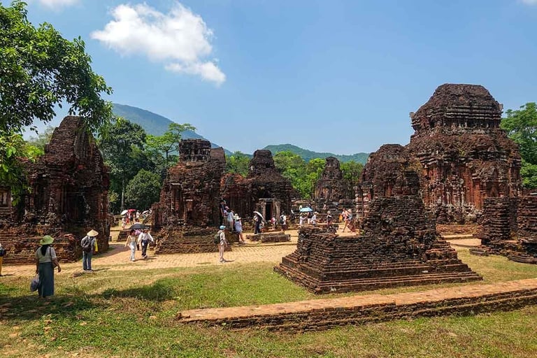 my son sanctuary ruins with mountains and tourists in hoi an vietnam