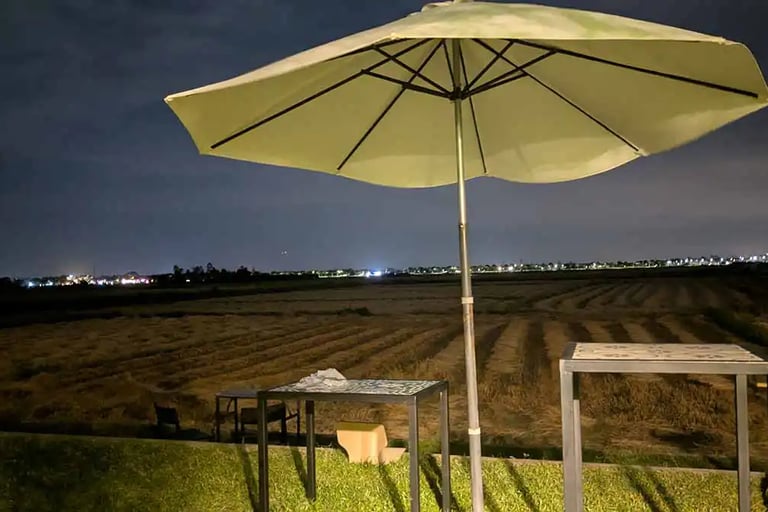 Night view from coworking space overlooking rice fields in Hoi An, Vietnam