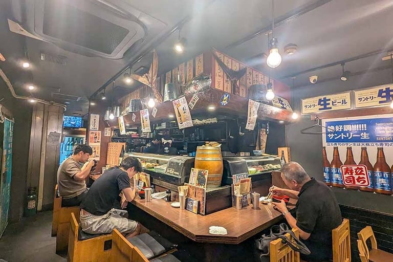 Interior of a traditional Japanese restaurant with diners enjoying a meal.