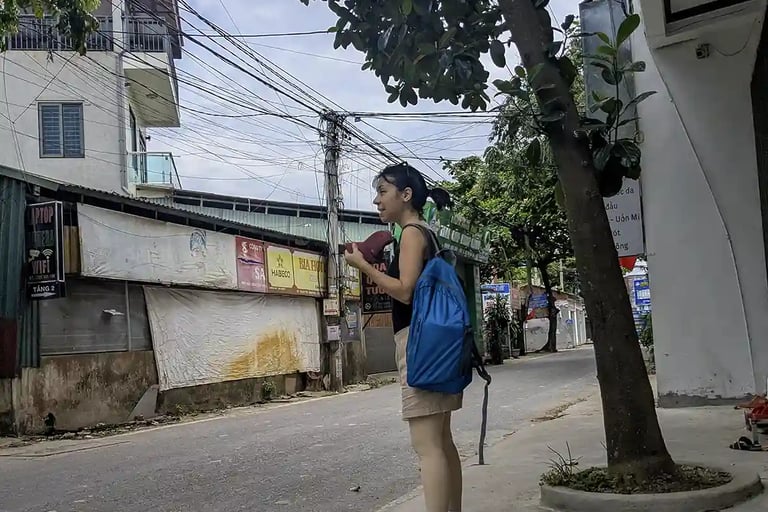 Waiting for a ride on a quiet village street after visiting a pharmacy in northern Vietnam