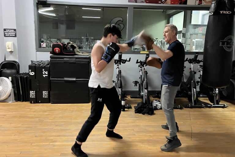 joe mccutcheon boxer instructor with teen working out