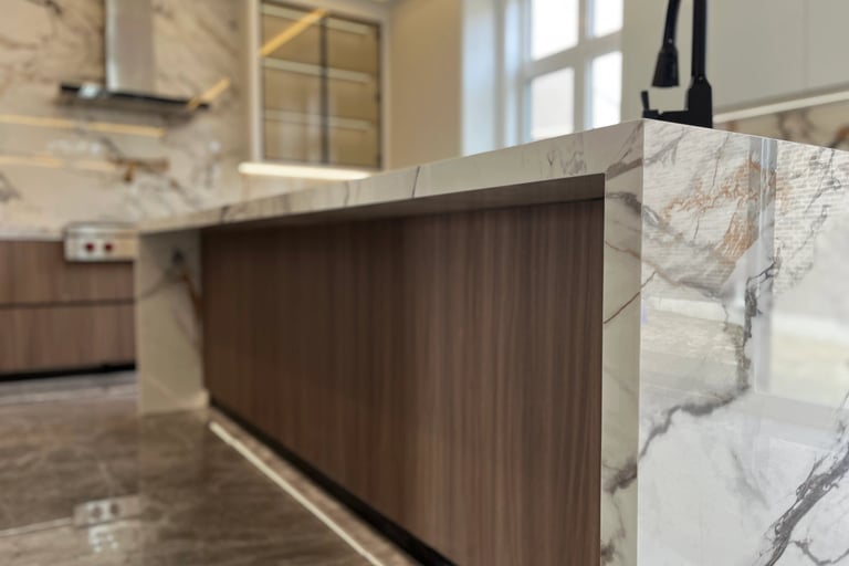 Close-up of a seamless 45-degree mitered edge on a Calacatta Sintered Stone island by Maple Style Li