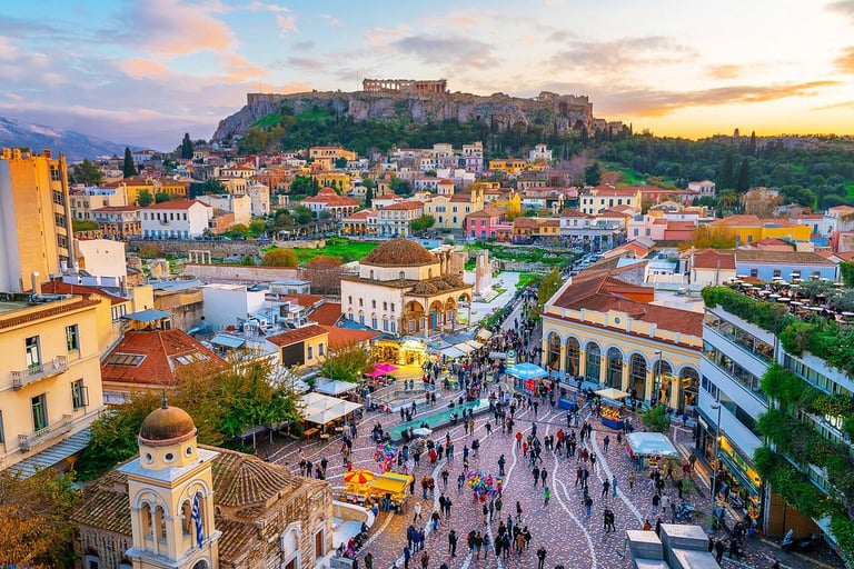 Aerial view of Monastiraki Square in Athens, Greece with the Acropolis and Parthenon at sunset.