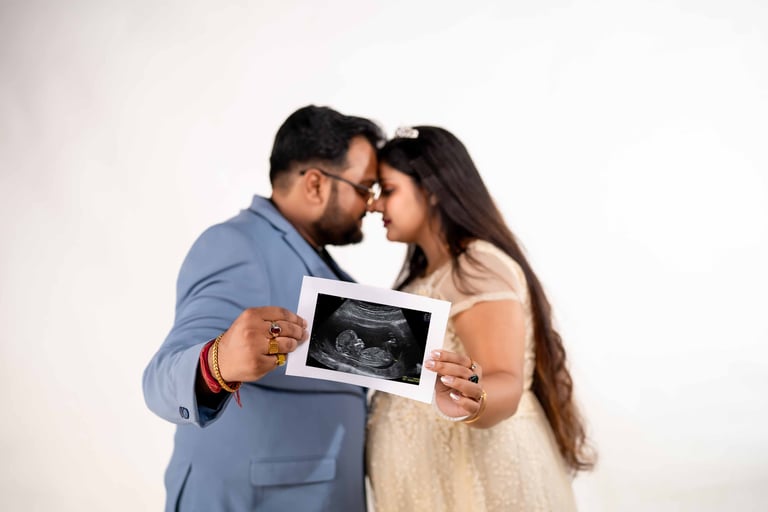 Husband and wife celebrating pregnancy during indoor maternity session