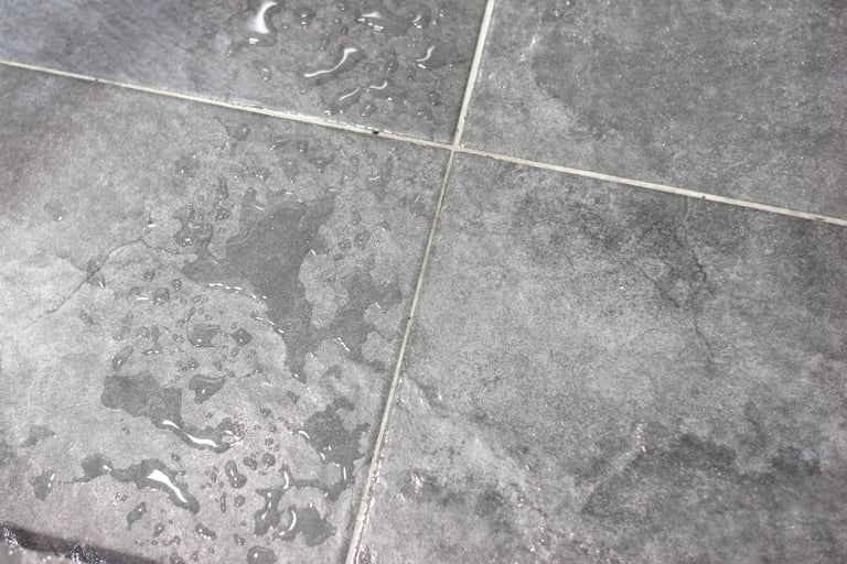 Bathroom stone surface in wet and dry tonal shift, French Mediterranean.