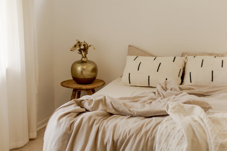 Linen and plaster carrying color in a French Mediterranean bedroom.