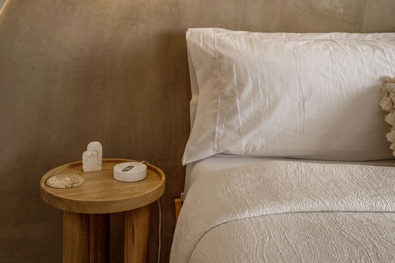 Linen, wood and plaster in a French Mediterranean bedroom.