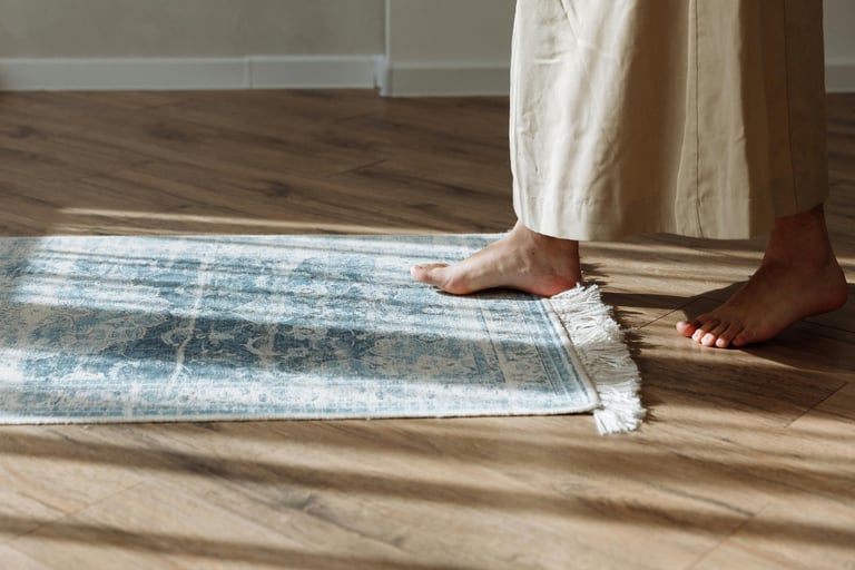 Wood floor beside the bed in a French Mediterranean bedroom.