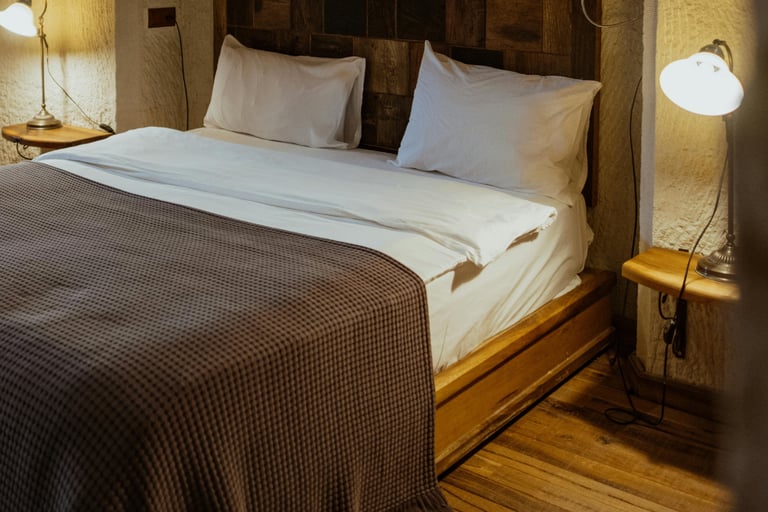 Wood and plaster meeting in a French Mediterranean bedroom.