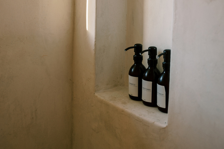 Tadelakt wall meeting stone floor in a Mediterranean bathroom.