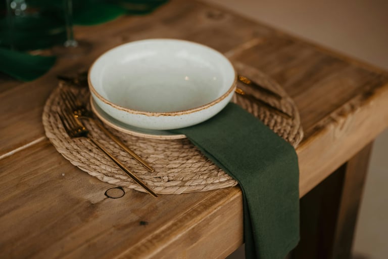 Muted olive and warm wood in a French Mediterranean dining room.