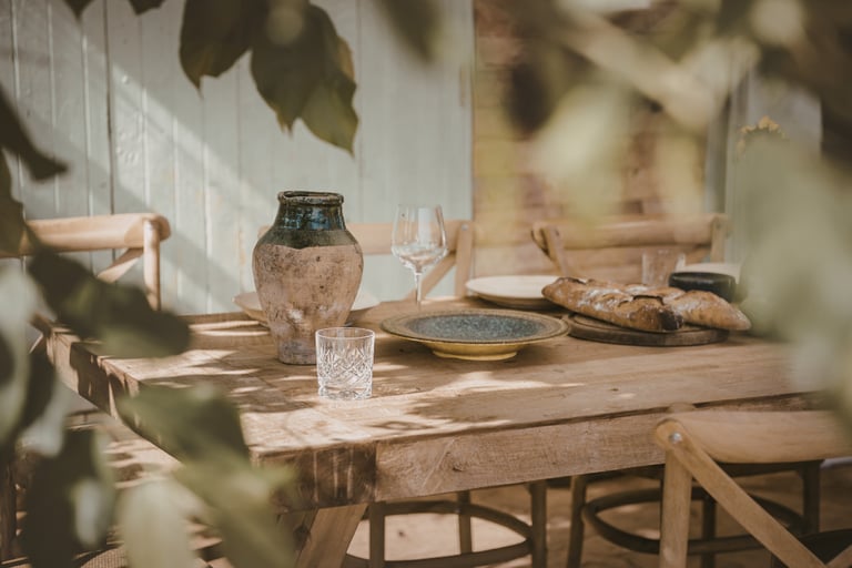 Steady southern light across a dining table in a French Mediterranean room.