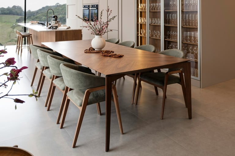 Dining chairs around a table with even spacing in a French Mediterranean room.