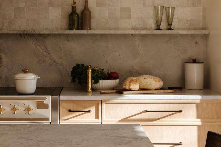 Stone counter meeting lime plaster in a French Mediterranean kitchen!