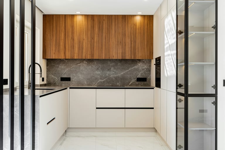 Closed cabinet fronts as continuous wall in a French Mediterranean kitchen!