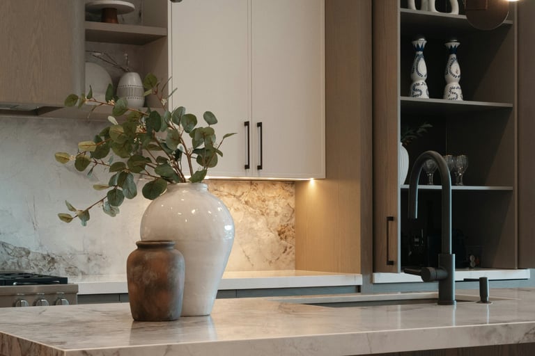 Soft task light across a kitchen counter in a French Mediterranean kitchen.