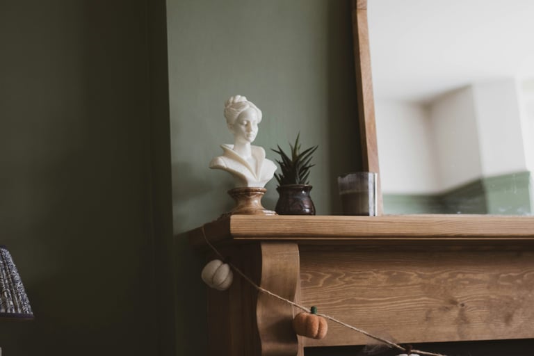 Muted olive and warm wood in a French Mediterranean living room.