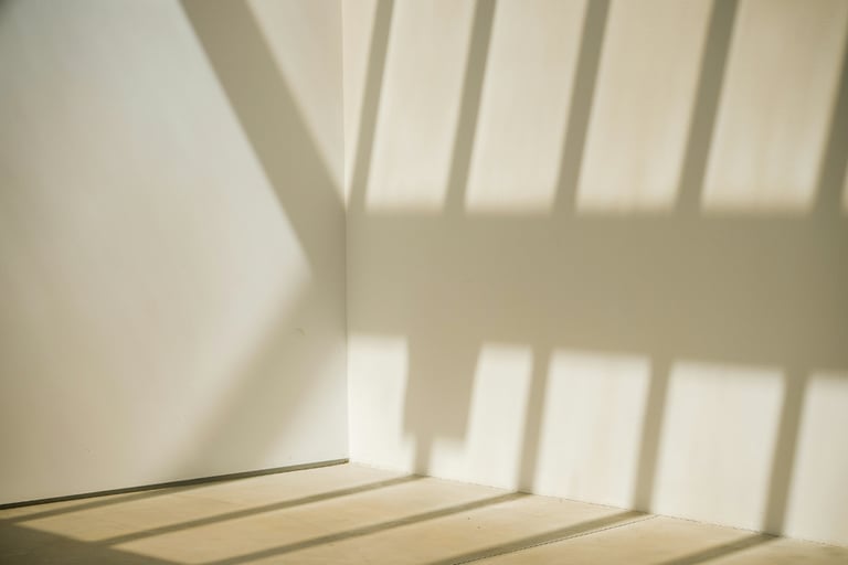 Empty corner with afternoon light in a French Mediterranean room.
