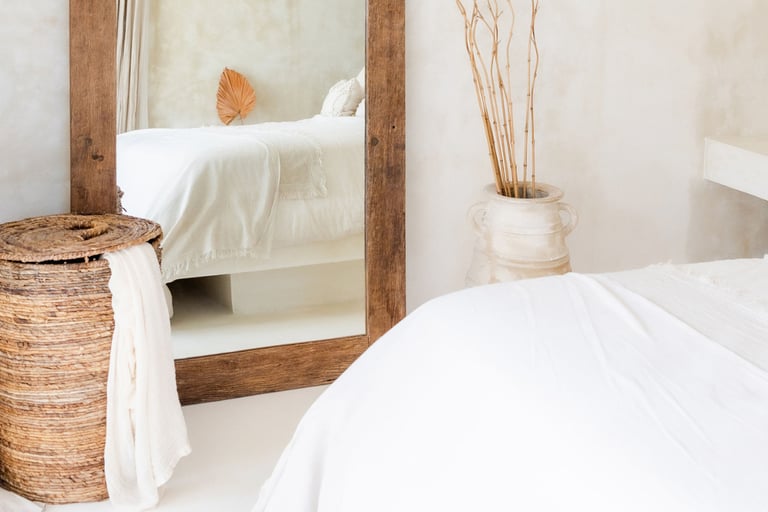 Tonal palette in a French Mediterranean bedroom — stone, linen, plaster.