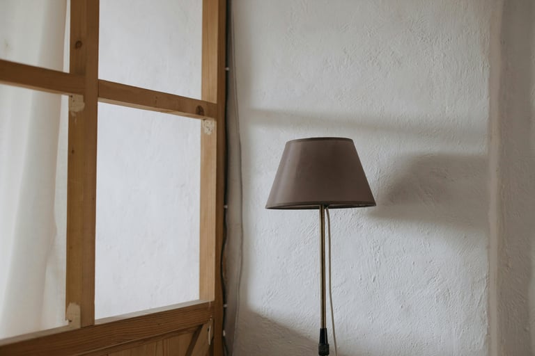 Detail of natural materials in a Mediterranean interior — plaster, linen, and wood in warm neutral t