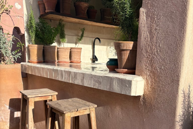 Warm stone and limewashed wall on a French Mediterranean terrace.