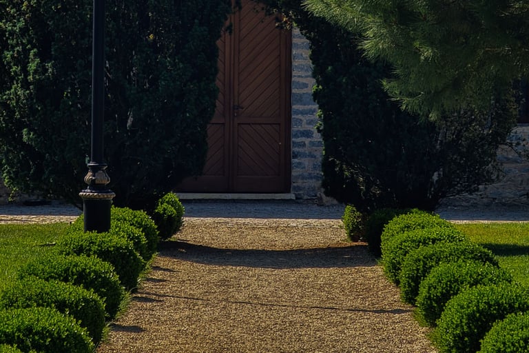Gravel meeting stone edge on a French Mediterranean terrace.