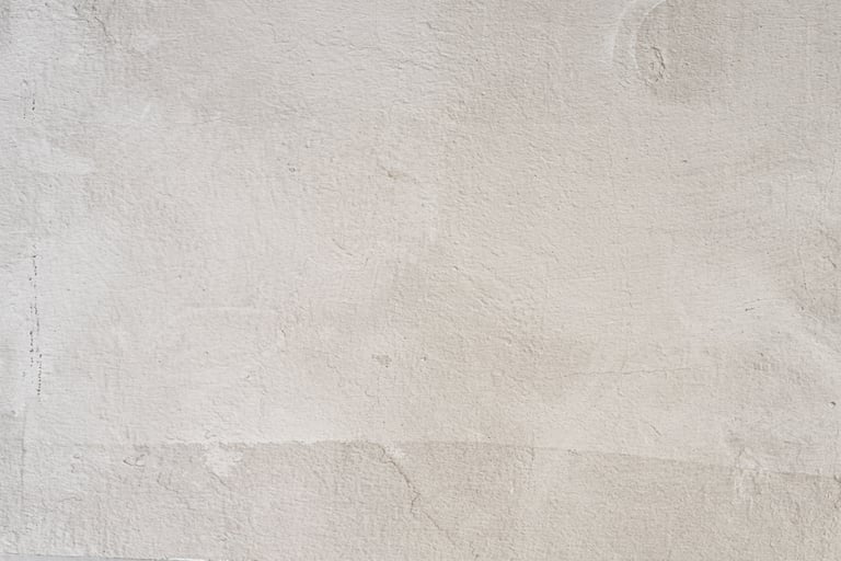 Aged lime-washed wall with traces of ochre and sand pigment.