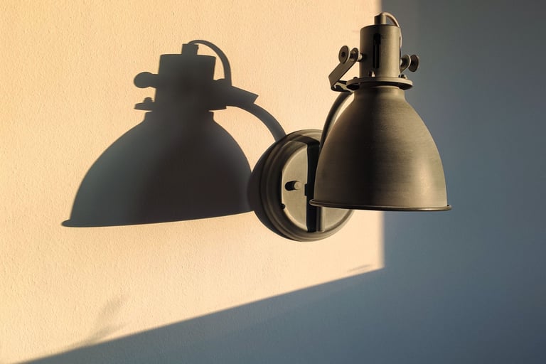 The same warm white wall shown in warm afternoon light and shadow.