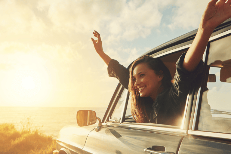 A happy female riding in a car after learning what to expect from counselling.
