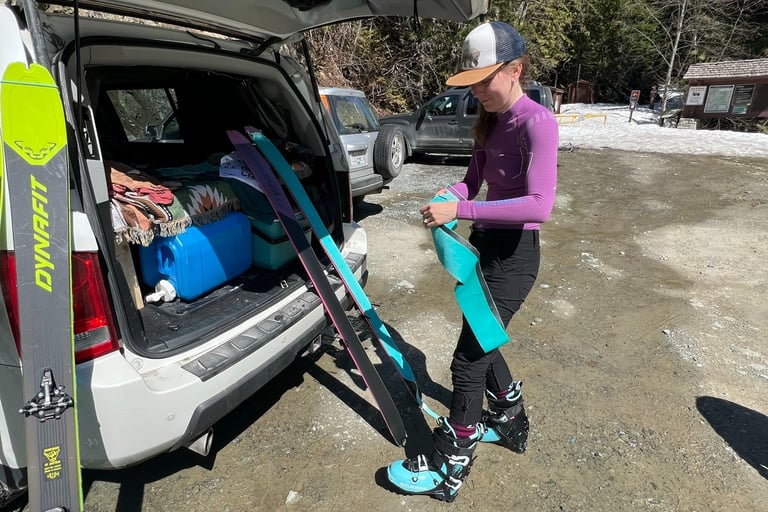 a woman is standing in the snow with her skis