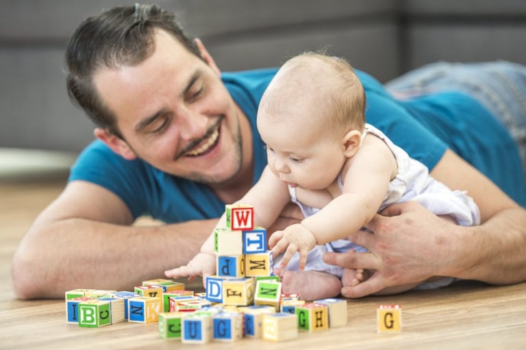 Dad playing with baby