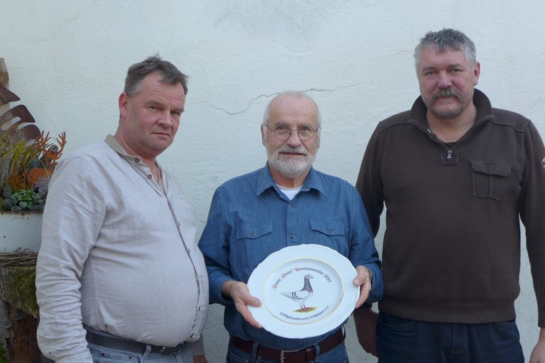 three men standing next to each other holding plates