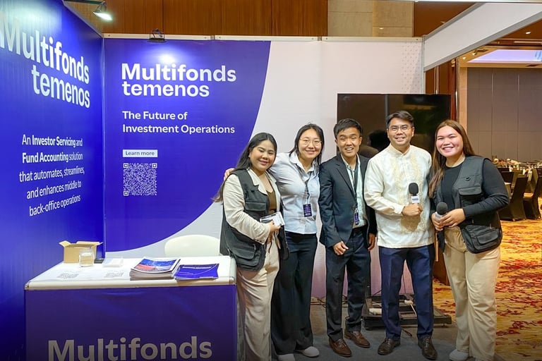 a group of people standing around a table with a microphone