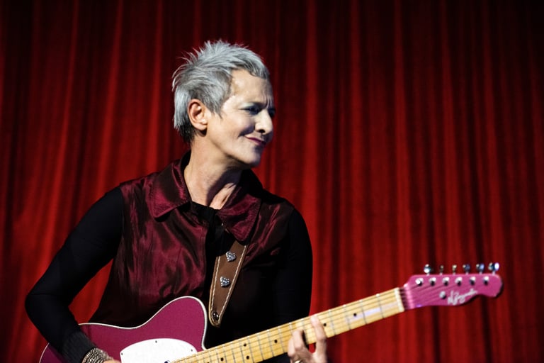 a woman with a guitar and a guitar