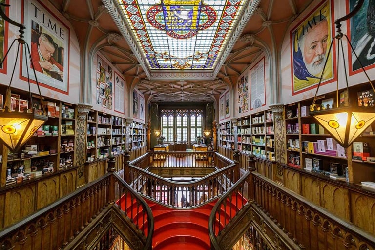 a staircase way with a red carpet and a skylight