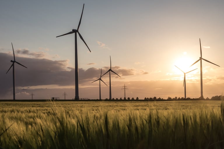 Wind Turbines Generating Noise against Sunset