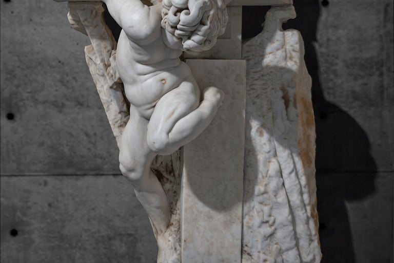 White marble sculpture depicting a child inserted into a stone cross, attached to a gray wall.