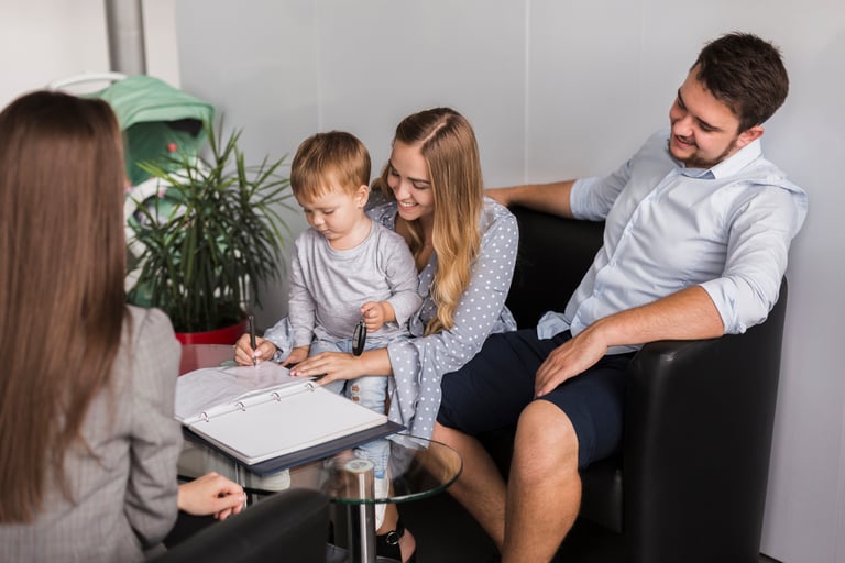 a family sitting on a couch in a living room