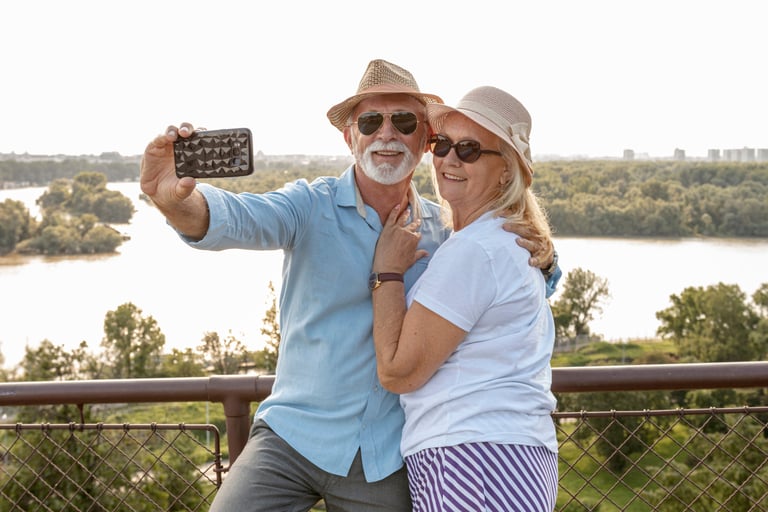 a man and woman taking a selfie with a cell phone