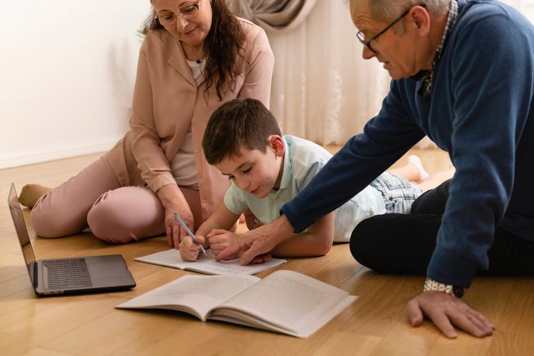 a man and woman sitting on the floor with a laptop